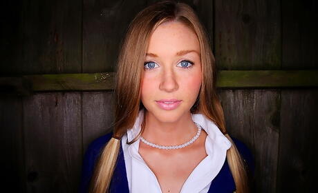 Shapely young Zoe Mae in skirt spreading her legs outside